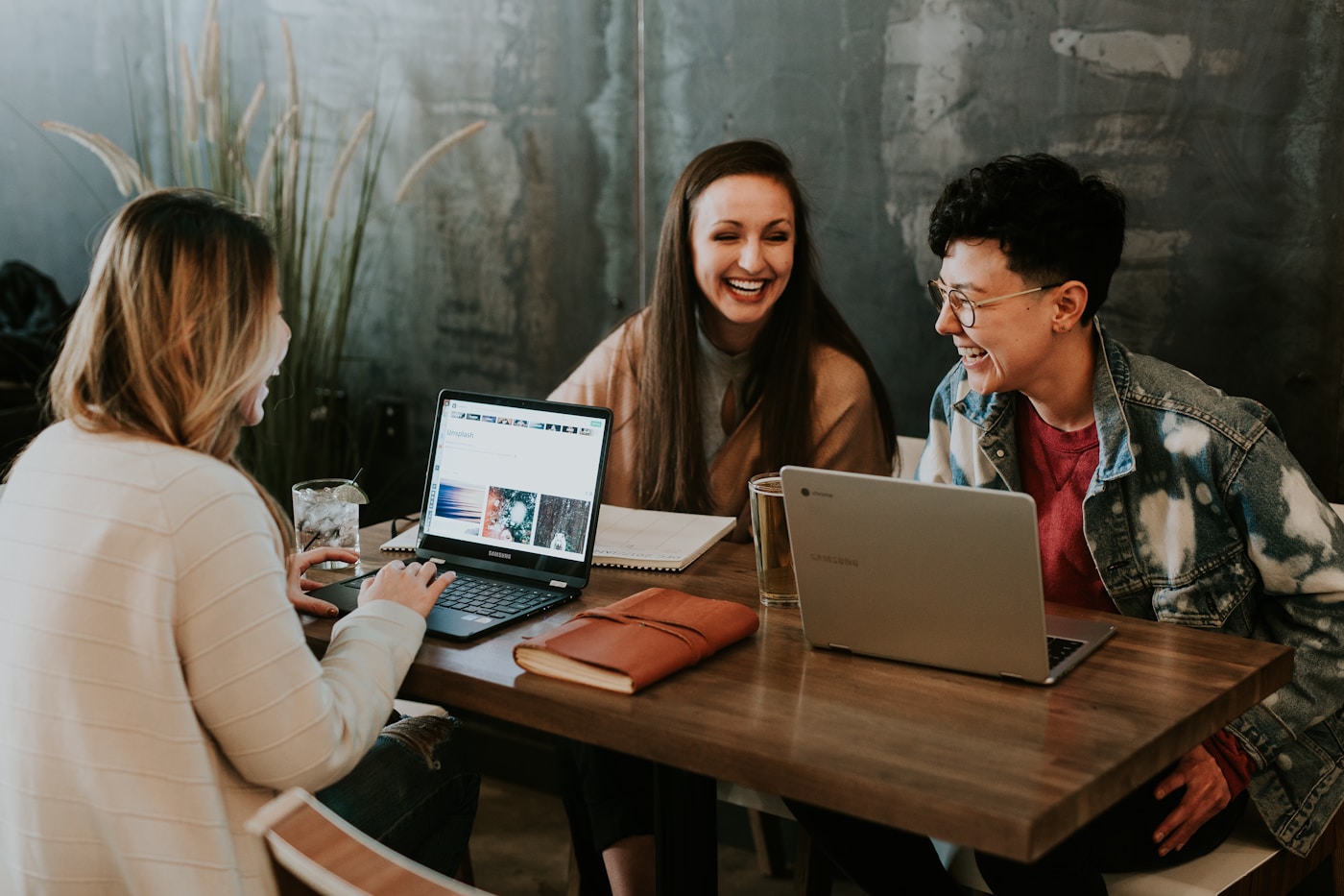 Professional team collaborating at a laptop — representative image for online workplace assessments